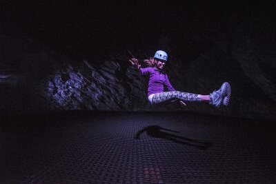 Child bouncing on Snowdonia cavern trampoline