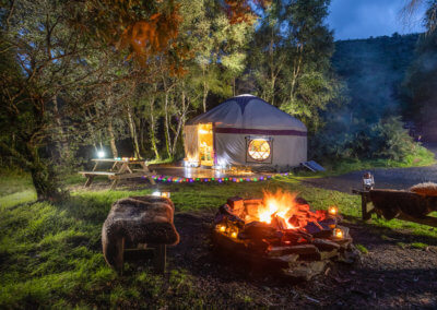 Family glamping Wales yurt with firepit lit