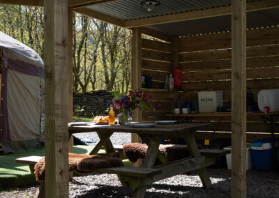 picnic table in shelter, Wales yurt glamping